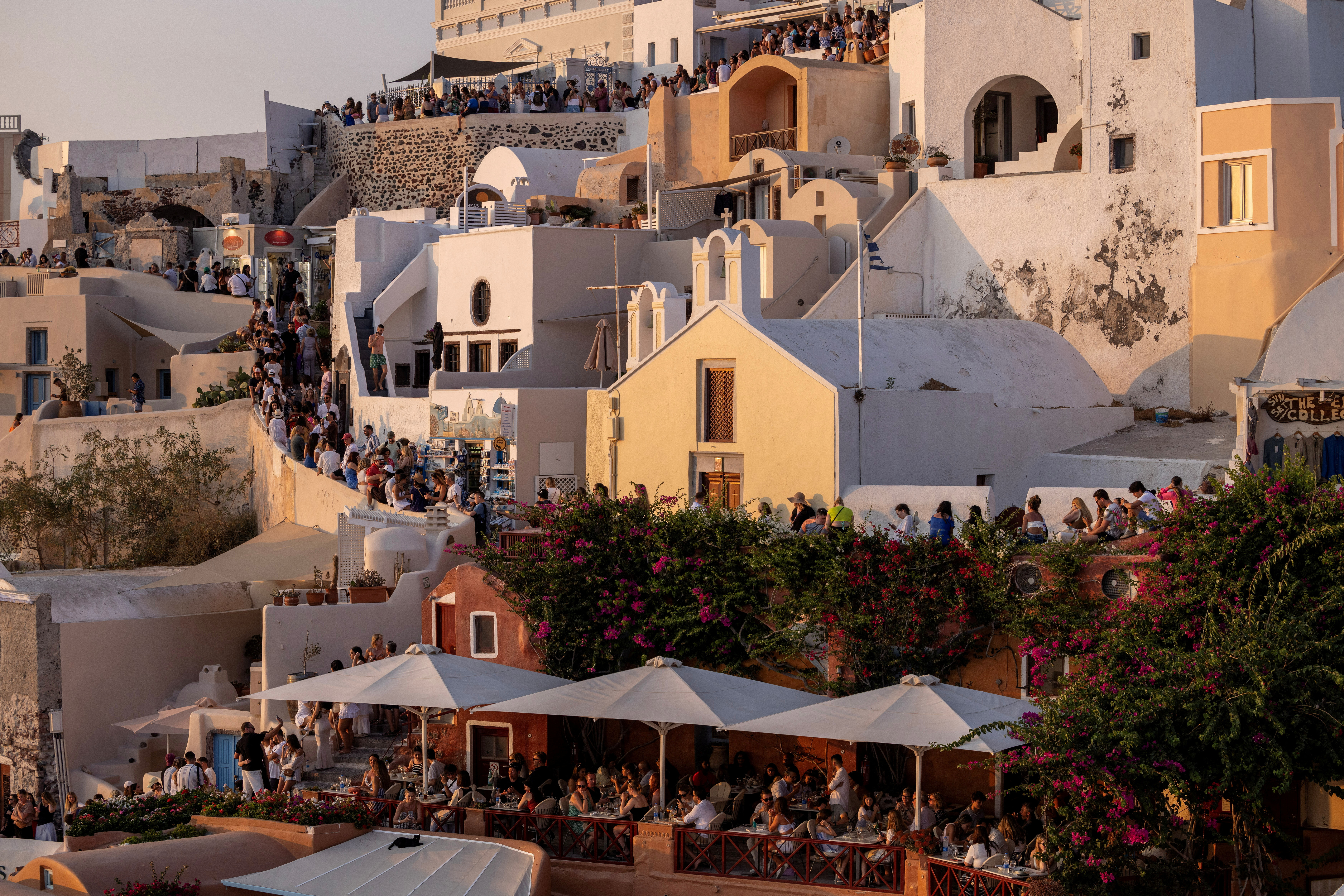 FILE PHOTO: Tourists wait to view Santorini’s famed sunset on the Greek island