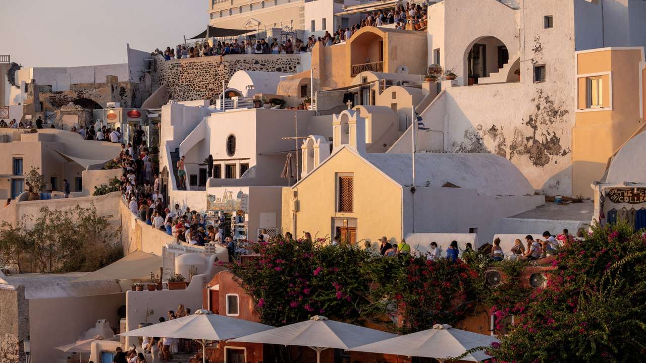 FILE PHOTO: Tourists wait to view Santorini’s famed sunset on the Greek island