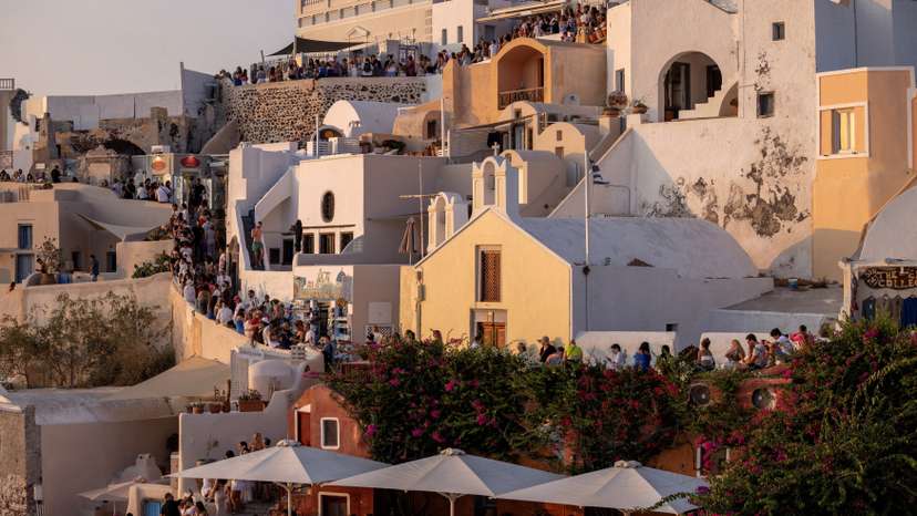 FILE PHOTO: Tourists wait to view Santorini’s famed sunset on the Greek island