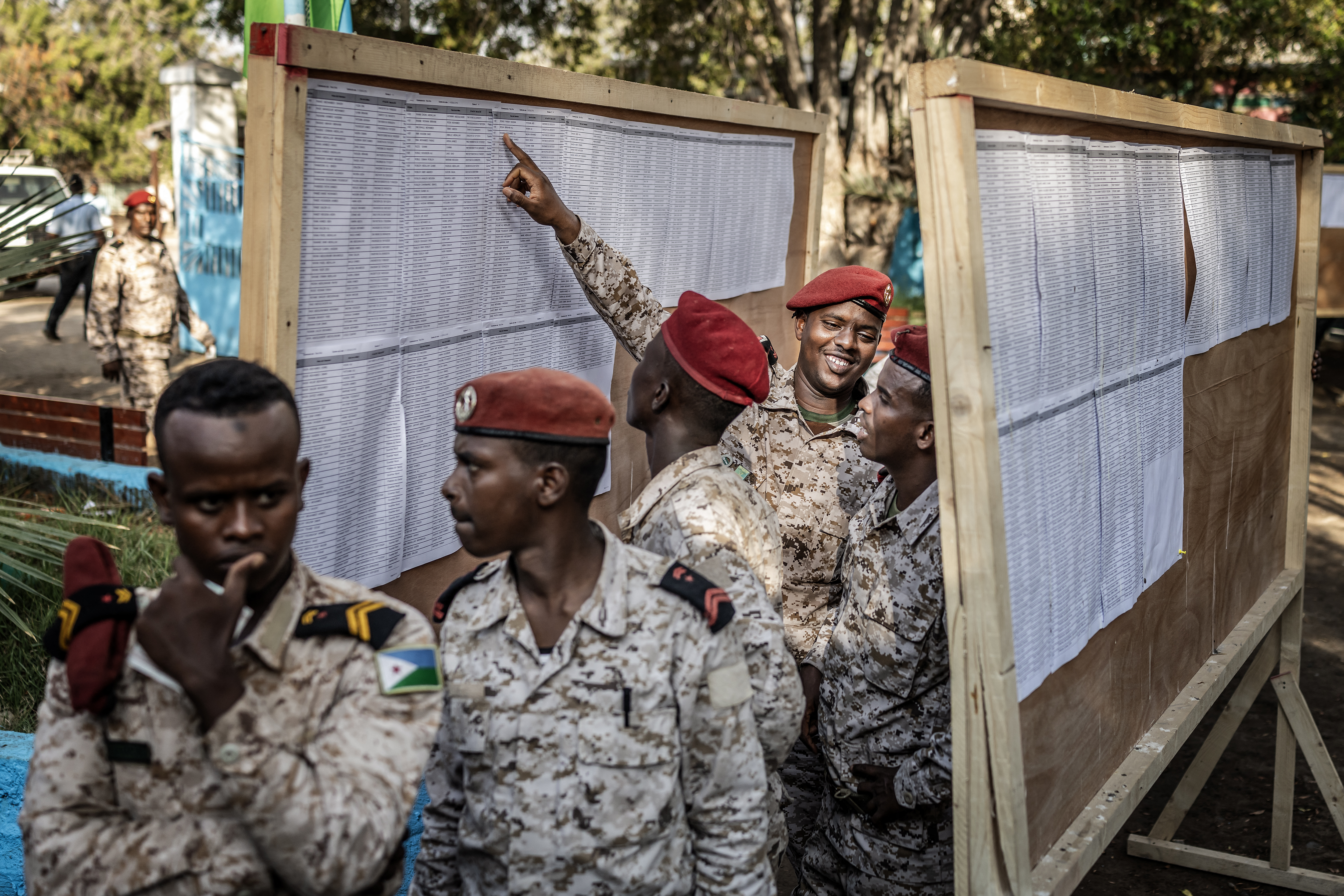 Members of the Djiboutian army react as they check the voters� roll before casting their ballots at a primary school serving as a polling station in Djibouti, on April 10, 2026, during the 2026 Djiboutian presidential elections. (Photo by Luis TATO / AFP)