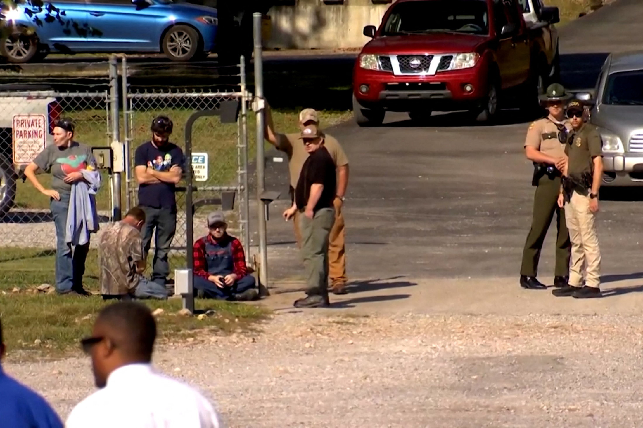 Law enforcement officers guard a gate outside the Accurate Energetic Systems military explosives plant in Bucksnort