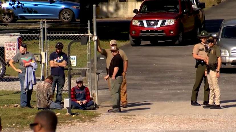 Law enforcement officers guard a gate outside the Accurate Energetic Systems military explosives plant in Bucksnort