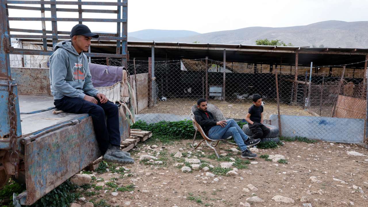 Palestinian shepards sit by livestock pen, few days after Bedouins said that Israeli settlers took livestock from the village of Ein al-Auja