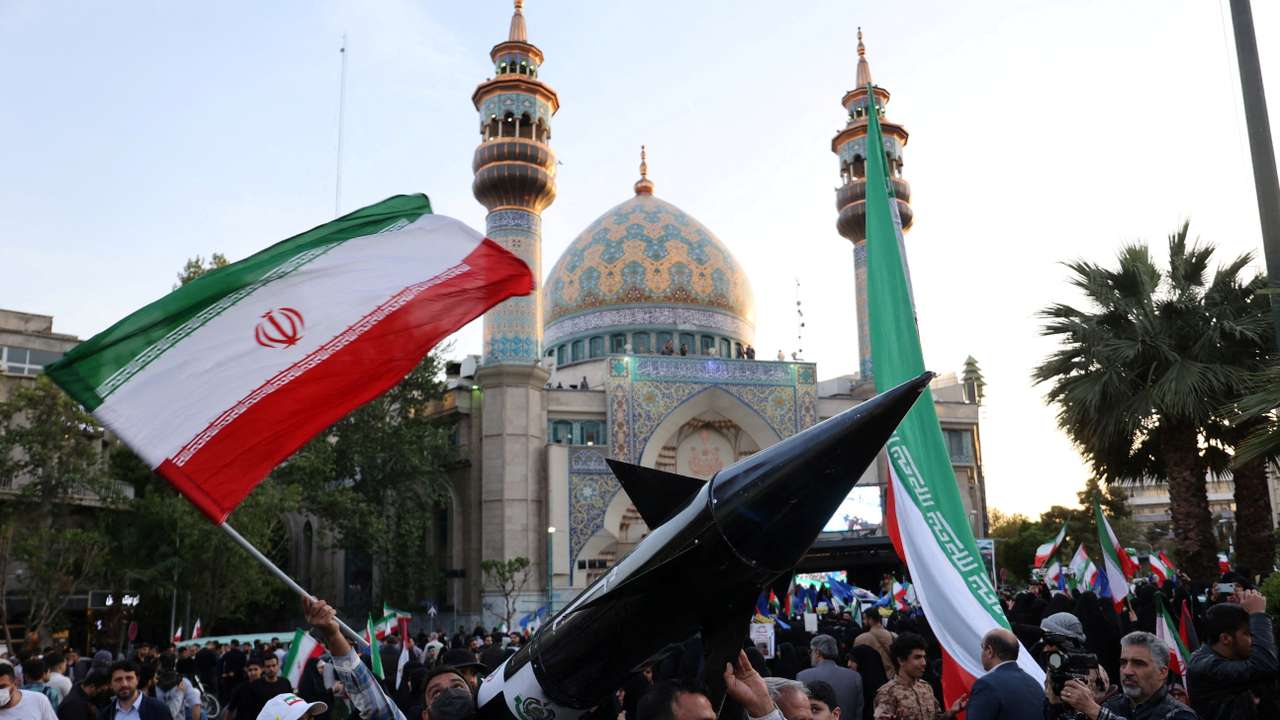 FILE PHOTO: Iranians carry a model of a missile during a celebration following the IRGC attack on Israel, in Tehran