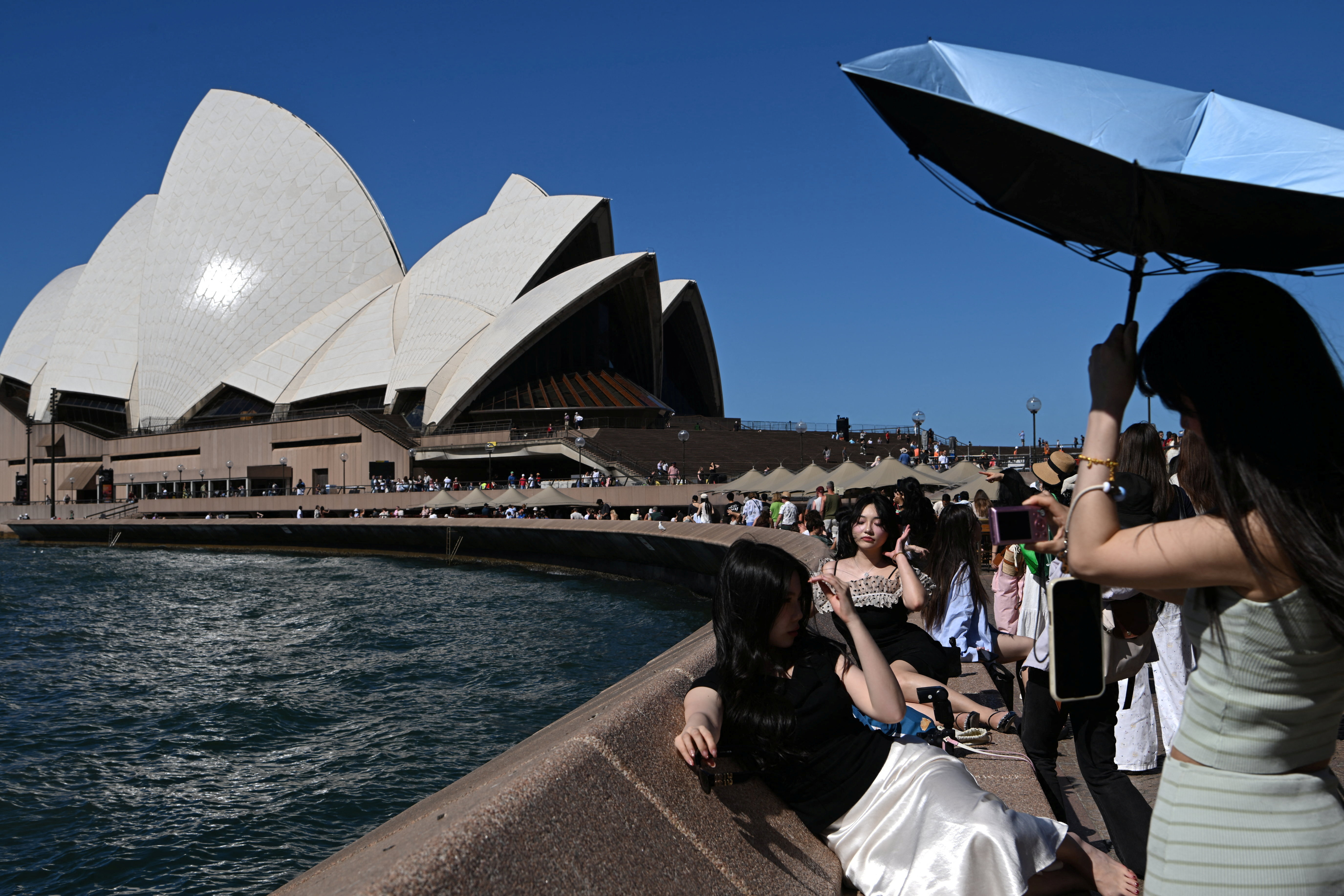 People take pictures near the Opera House
