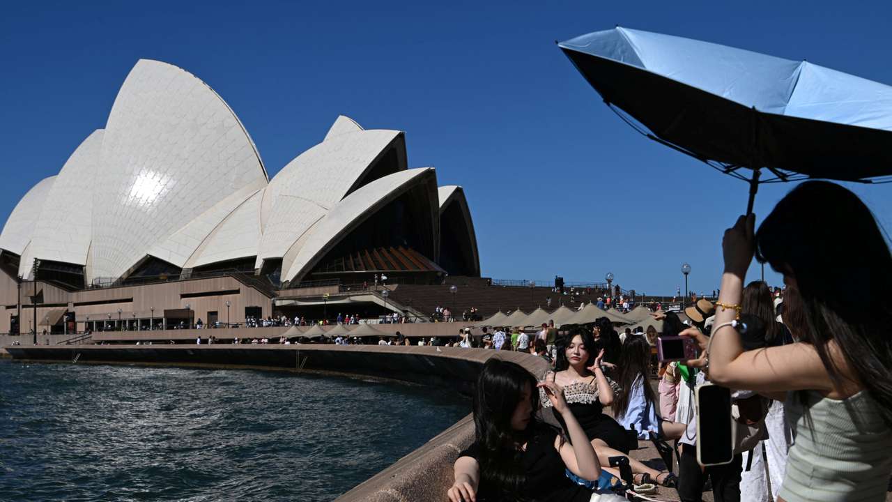 People take pictures near the Opera House