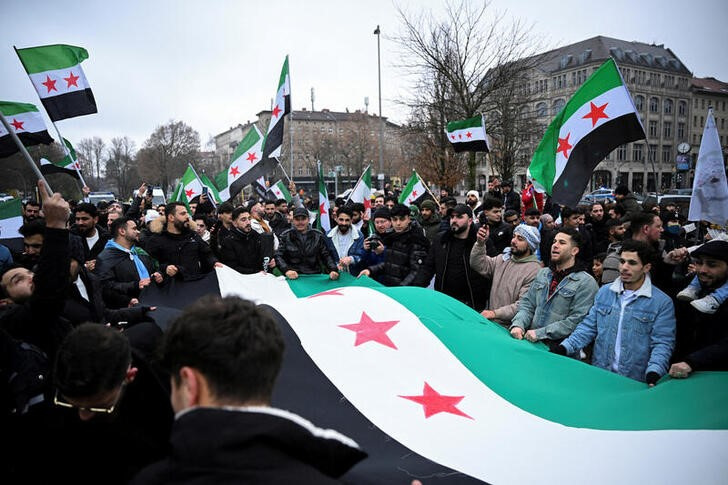 People gather on the streets, after Syrian rebels announced that they have ousted Syria's Bashar al-Assad, in Berlin