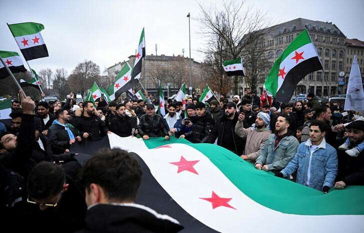 People gather on the streets, after Syrian rebels announced that they have ousted Syria's Bashar al-Assad, in Berlin