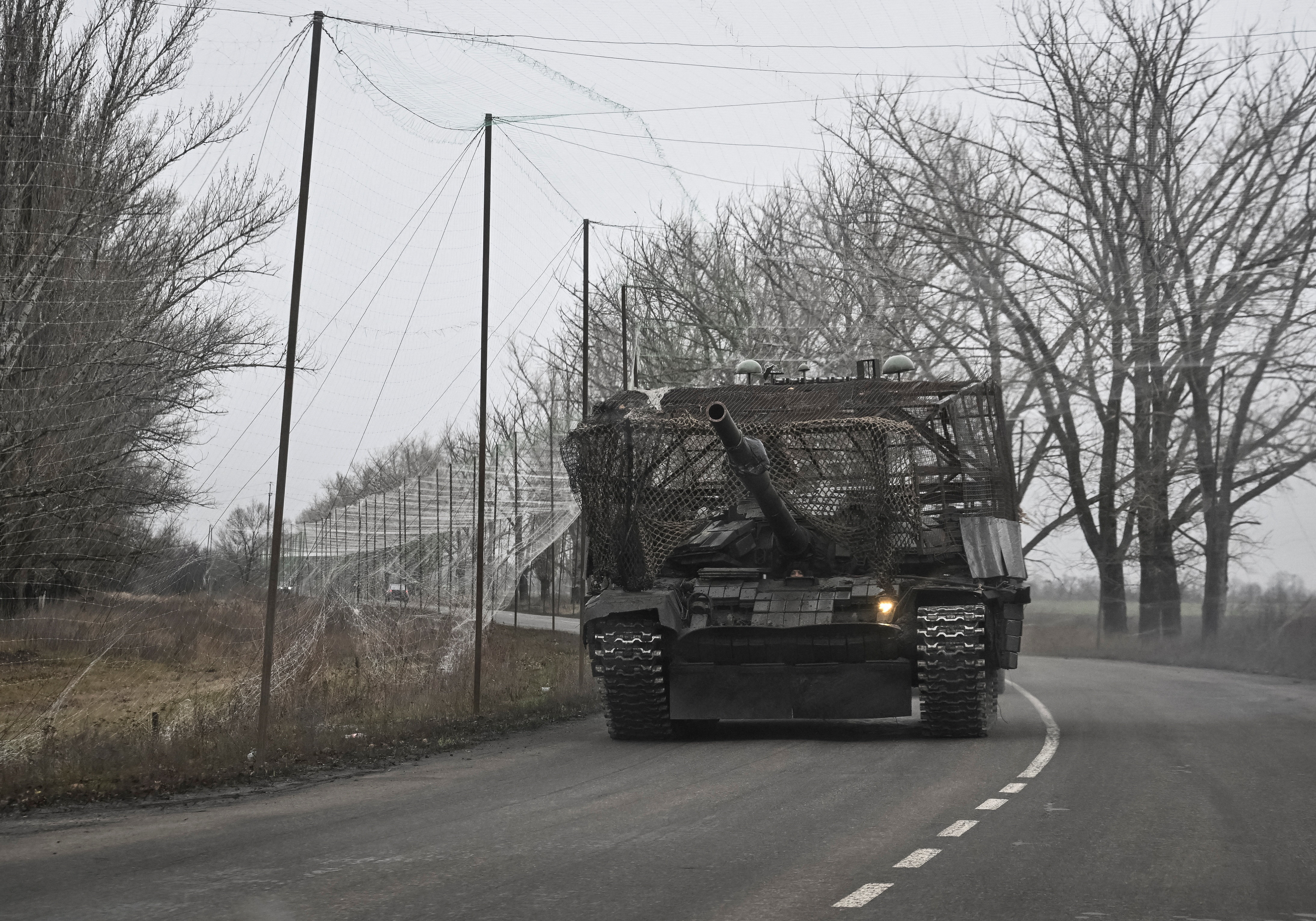 Ukrainian servicemen ride a tank near a front line near the town of Pokrovsk