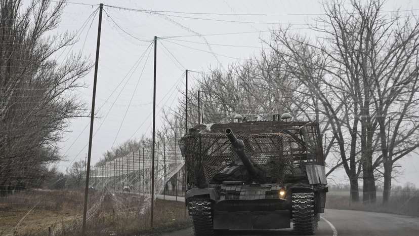 Ukrainian servicemen ride a tank near a front line near the town of Pokrovsk