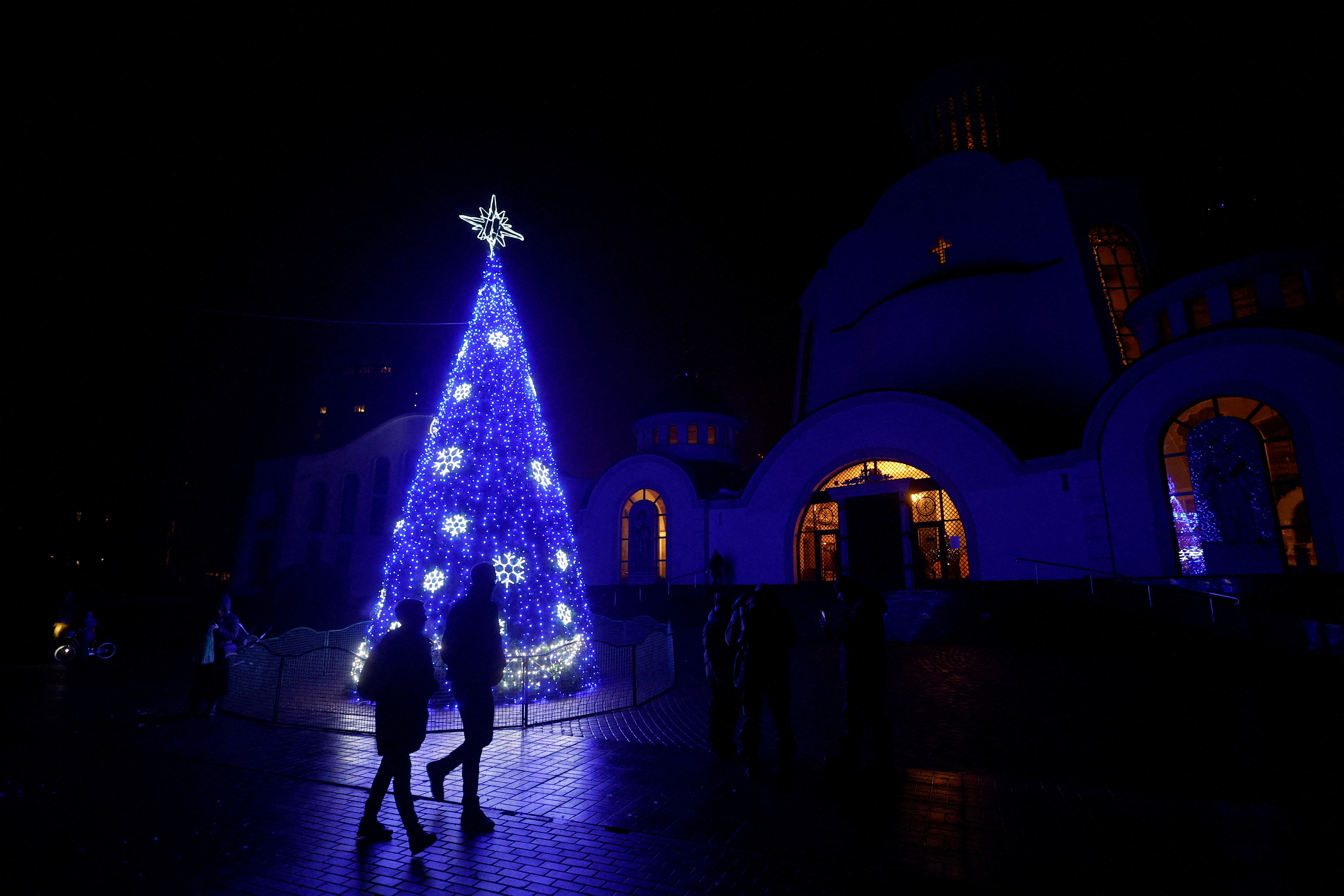 FILE PHOTO: Christmas tree is seen in front of an Orthodox cathedral during a service on the eve of Christmas in Kyiv