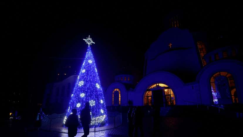 FILE PHOTO: Christmas tree is seen in front of an Orthodox cathedral during a service on the eve of Christmas in Kyiv