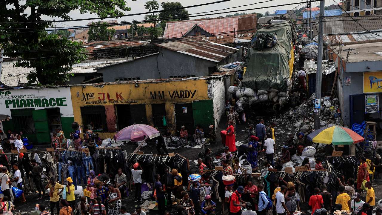 People shop at a public market, ahead of the parliamentary and presidential elections that are scheduled for December 20, in Kinshasa
