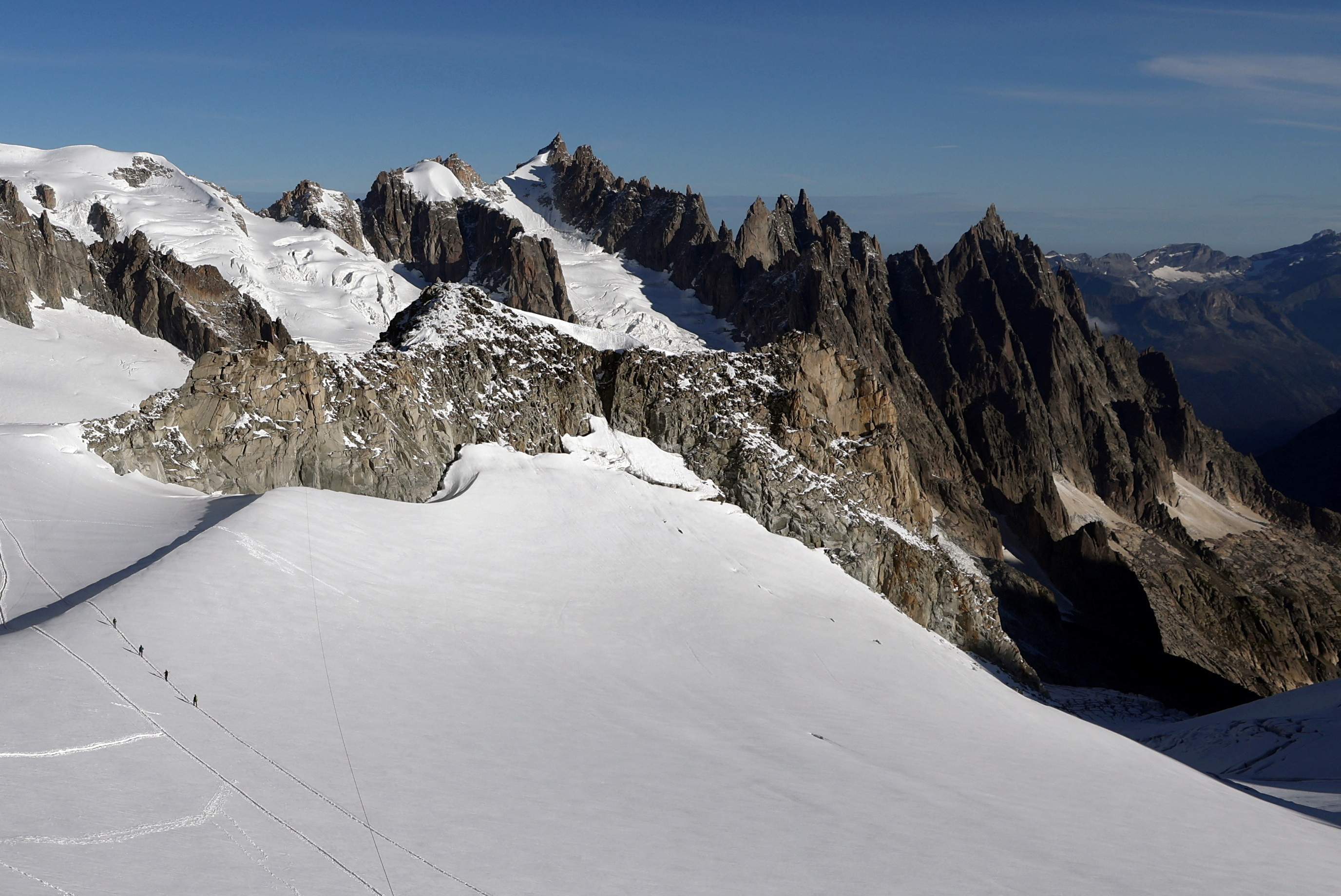 FILE PHOTO: Alpinists make their way across a glacier on the Italian side of Mont Blanc massif in Courmayeur