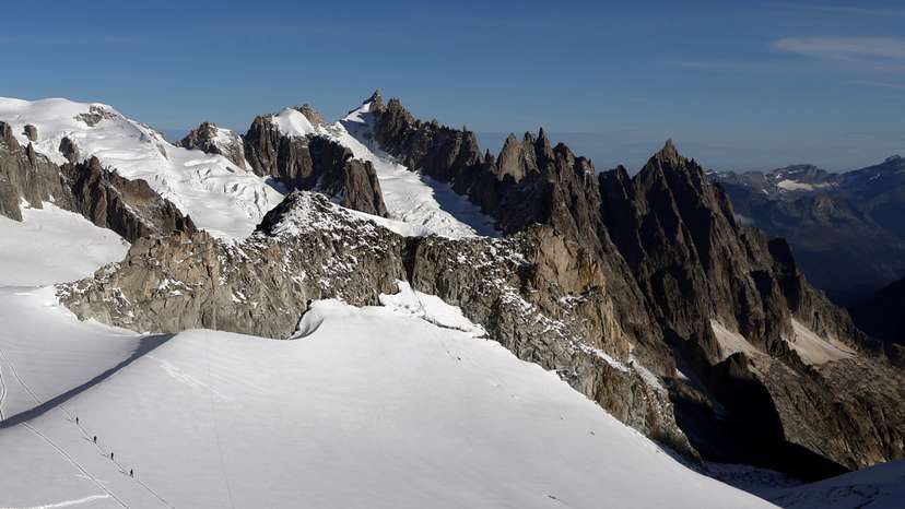 FILE PHOTO: Alpinists make their way across a glacier on the Italian side of Mont Blanc massif in Courmayeur