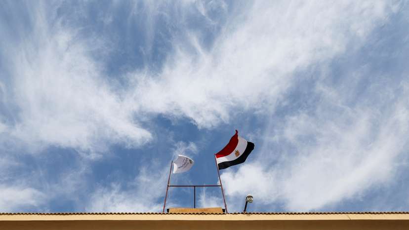 Egyptian flag waves on a gate at the Rafah border crossing