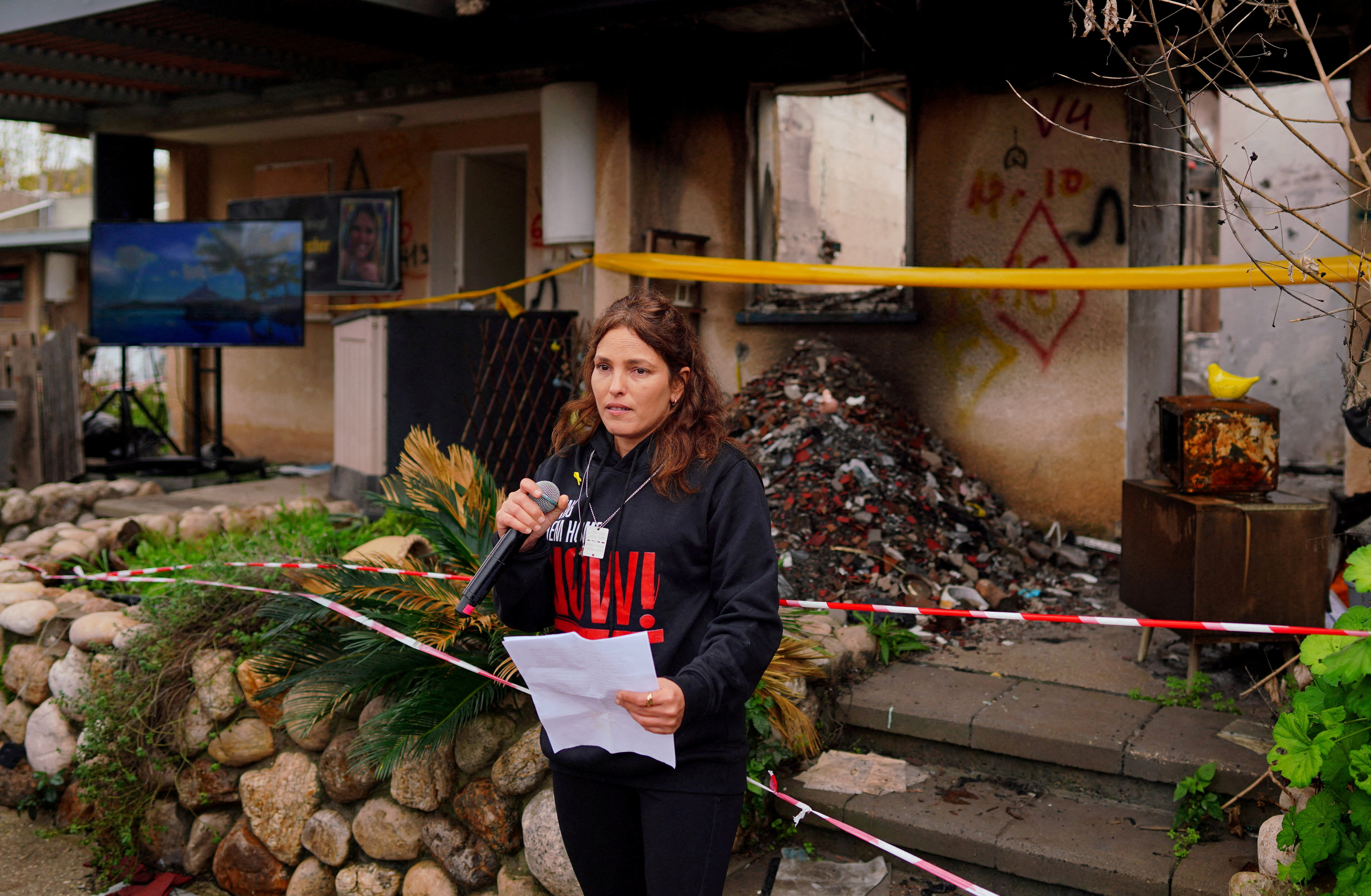 FILE PHOTO: Released hostage Amit Soussana talks to the press in front of her destroyed home at the Kibbutz Kfar Aza