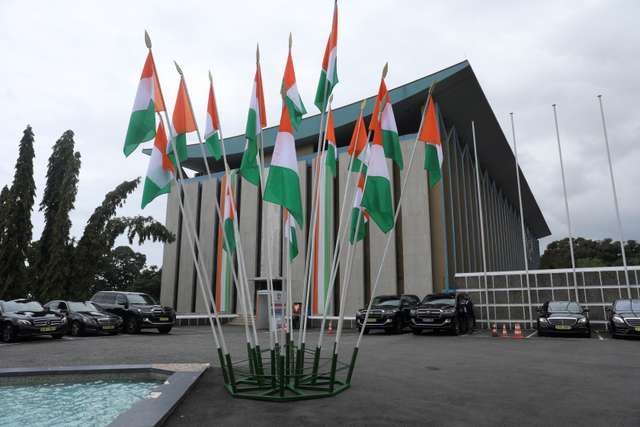 Ivory Coast's flags are pictured next to the presidential palace during the ceremony to commemorate the country's 60th Independence Day, in Abidjan