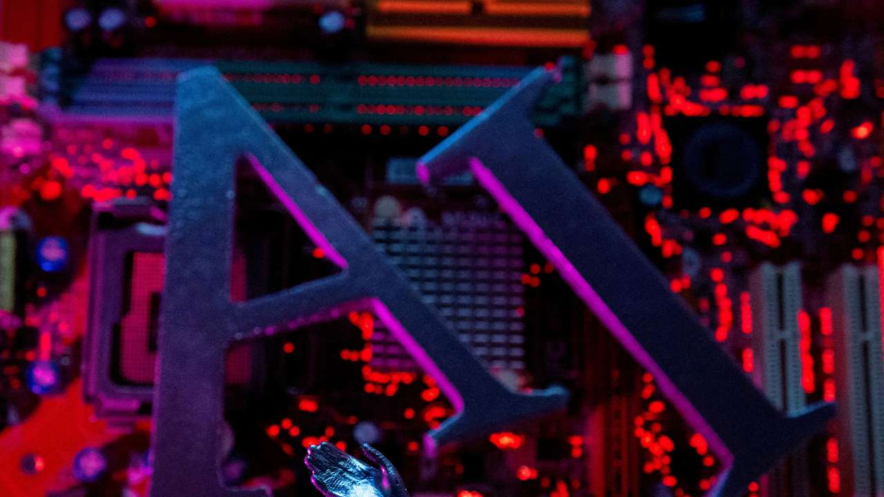 FILE PHOTO: Illustration shows AI (Artificial Intelligence) letters and robot hand