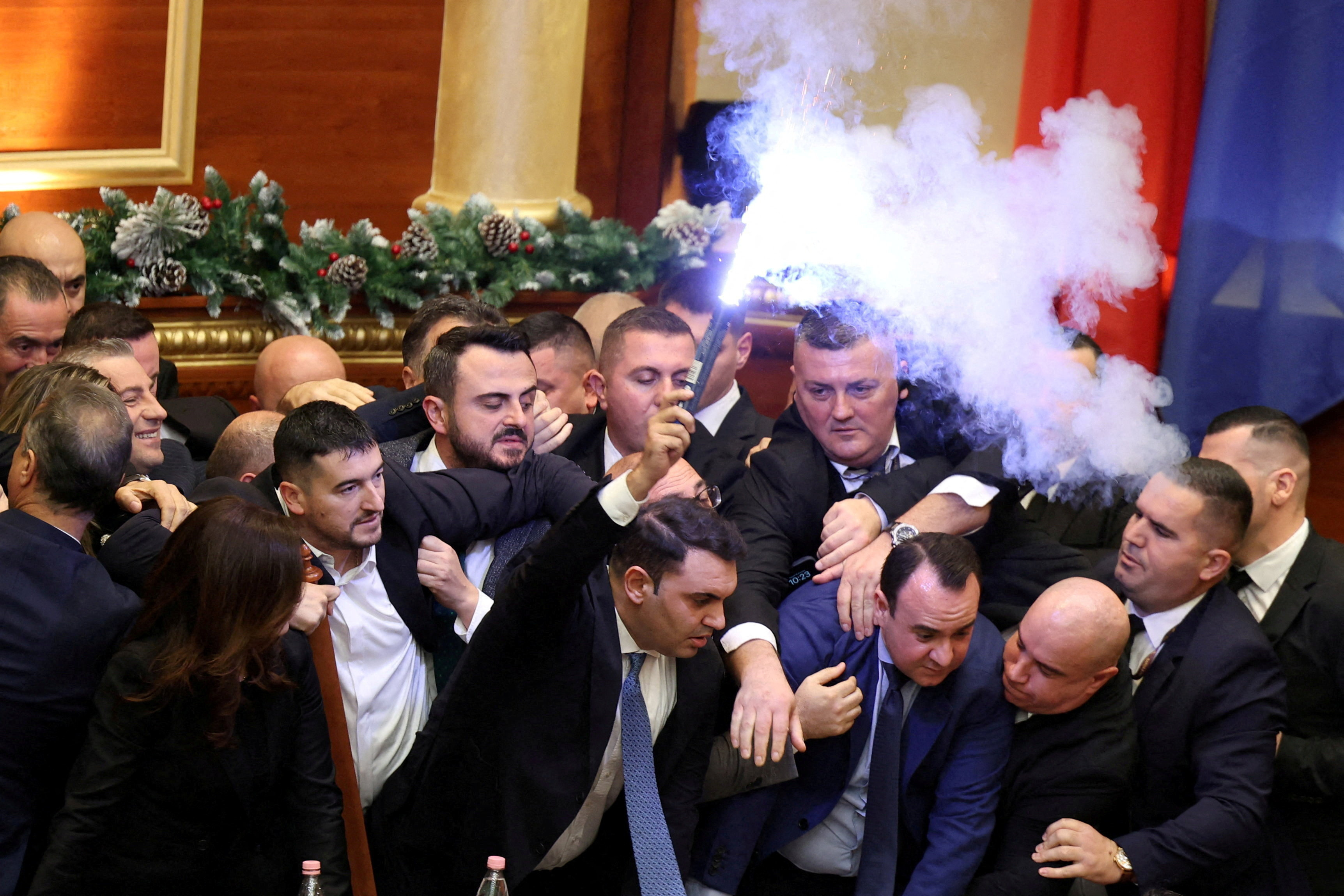 Members of parliament from the Democratic Party, Albania's biggest opposition party protest inside the parliament
