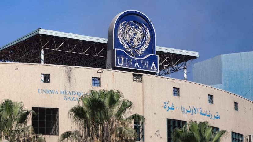 FILE PHOTO: Palestinians gather to inspect the damages at the headquarters of UNRWA in Gaza City