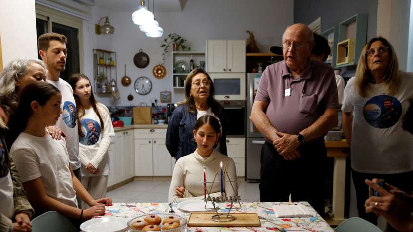 Family of Alon Ohel light the first candle to mark the first night of the Jewish holiday of Hanukkah in their house in Levon