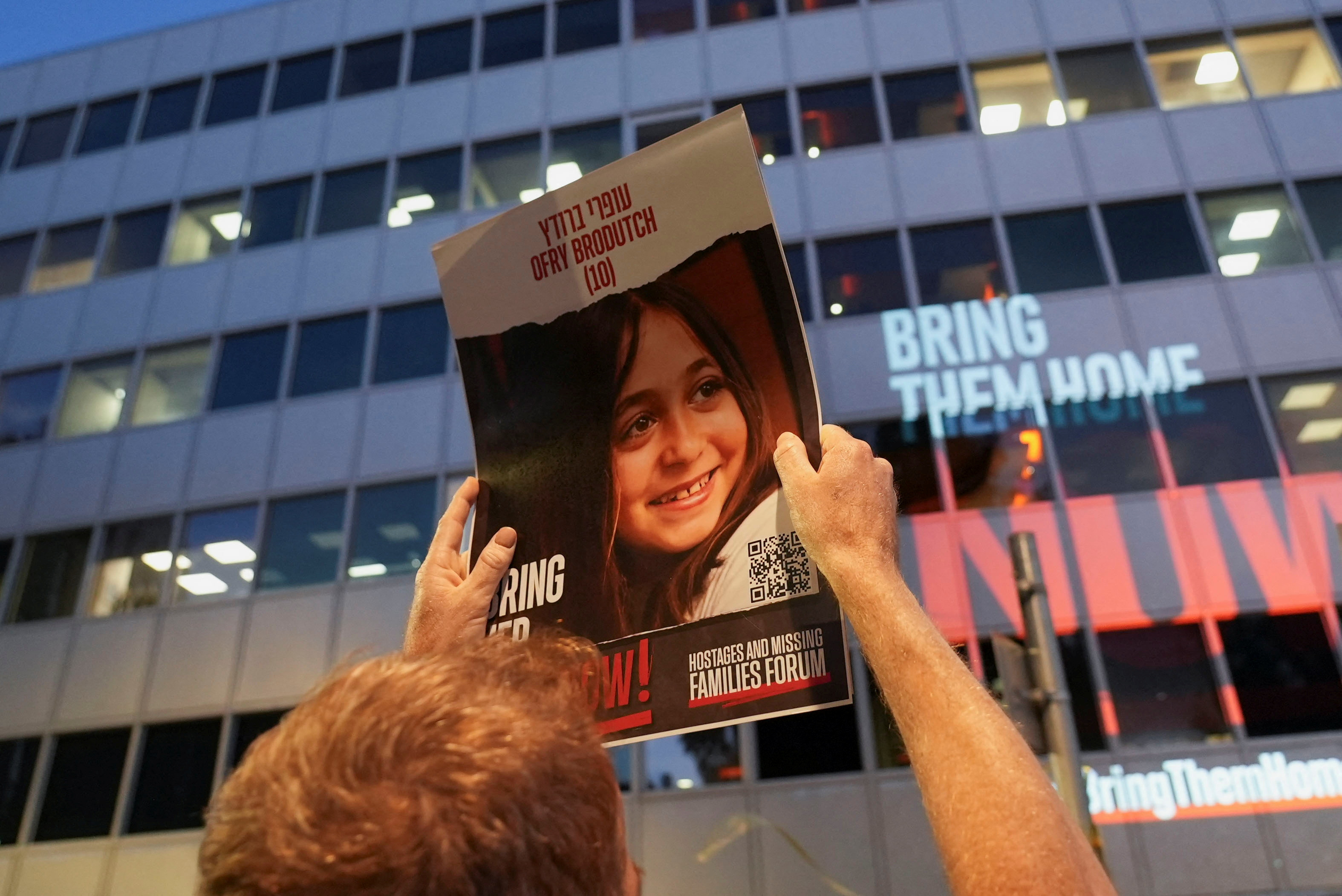 Protesters hold placards of Israeli child hostages outside the Tel Aviv offices of Nations International Children's Emergency Fund