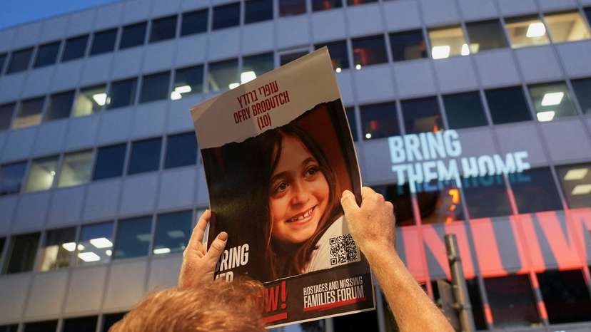 Protesters hold placards of Israeli child hostages outside the Tel Aviv offices of Nations International Children's Emergency Fund