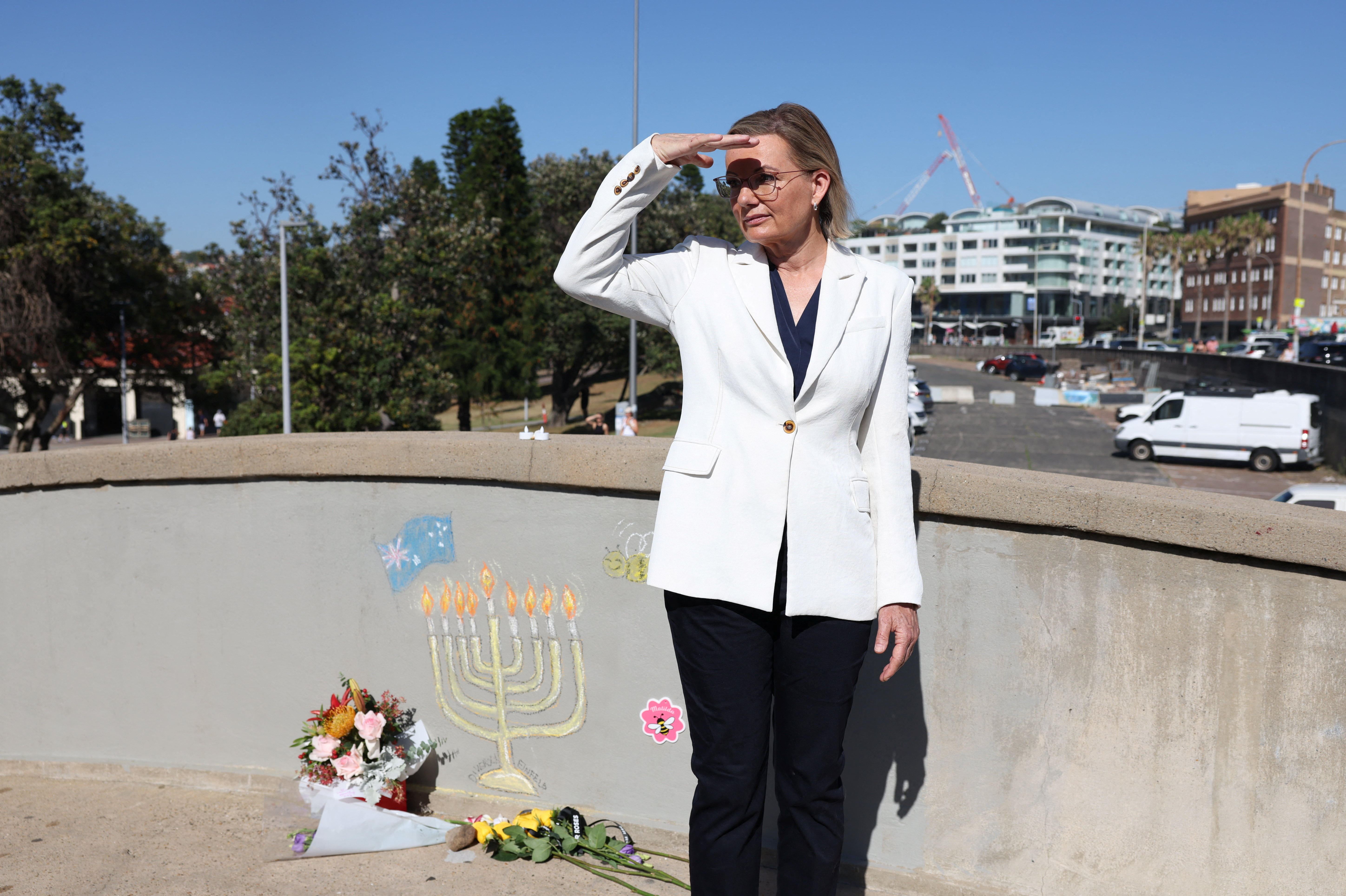 People visit the crime scene after it was reopened following the mass shooting at Bondi Beach