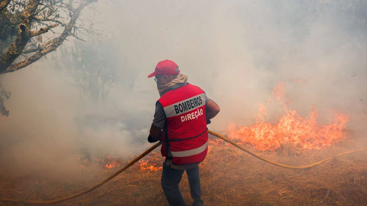 Firefighters extinguish a wildfire in Penalva do Castelo