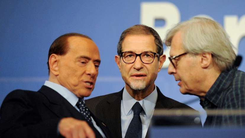 FILE PHOTO: Forza Italia party leader Silvio Berlusconi talks to candidate Nello Musumeci and Vittorio Sgarbi at the end of a rally for the regional election in Palermo