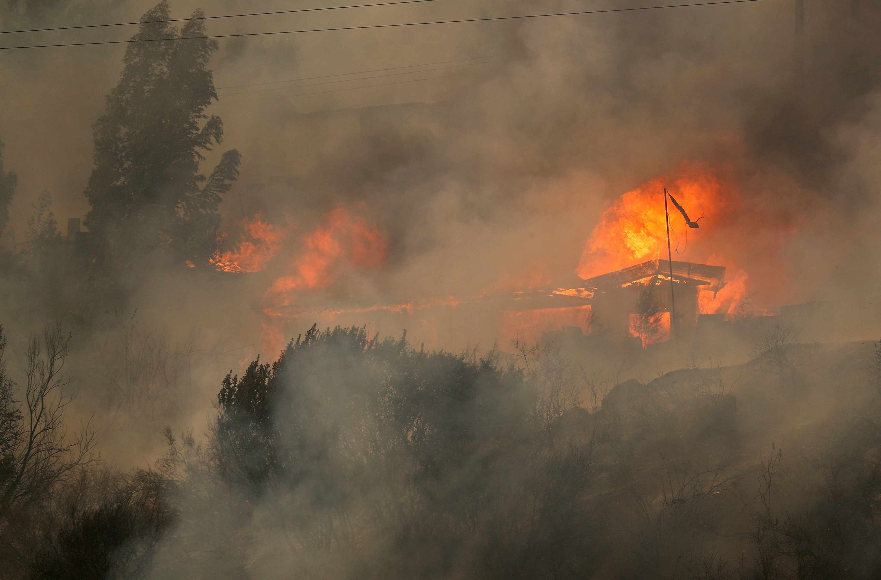 FILE PHOTO: Houses burn amid the spread of wildfires in Vina del Mar