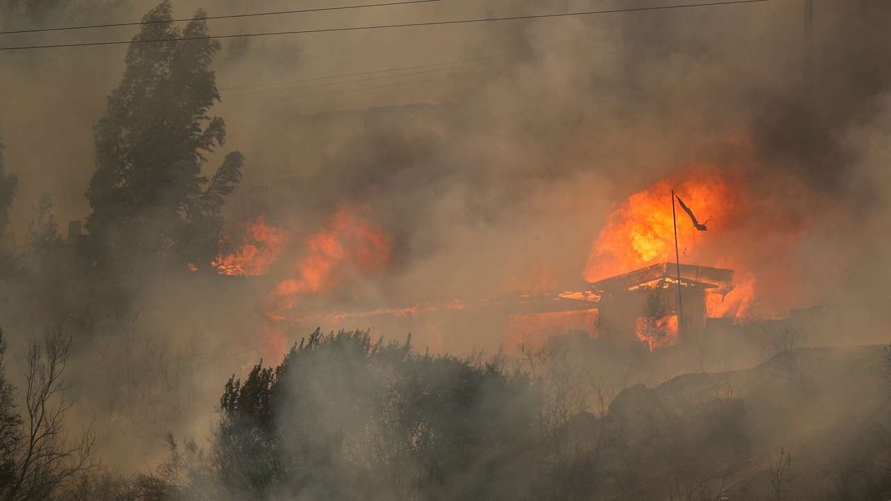 FILE PHOTO: Houses burn amid the spread of wildfires in Vina del Mar