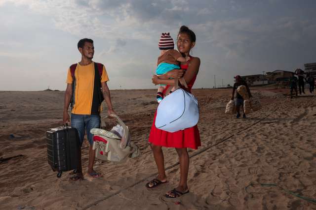 Tefé, Amazonas - Sept 20, 2024. Josiane and her family from the remote region of Fonte Boa search for a boat along the dried banks of Lake Tefé after traveling for hours to collect emergency government aid in response to the Amazon’s historic drought. River travel has become nearly impossible, disrupting daily life across the region. now a quick caption for this, adding the info and day