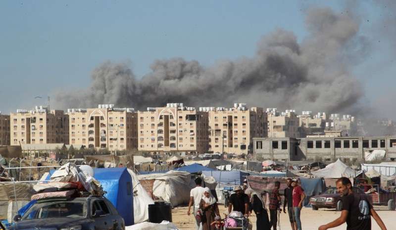 Smoke rises following an Israeli strike on a residential building, in Khan Younis