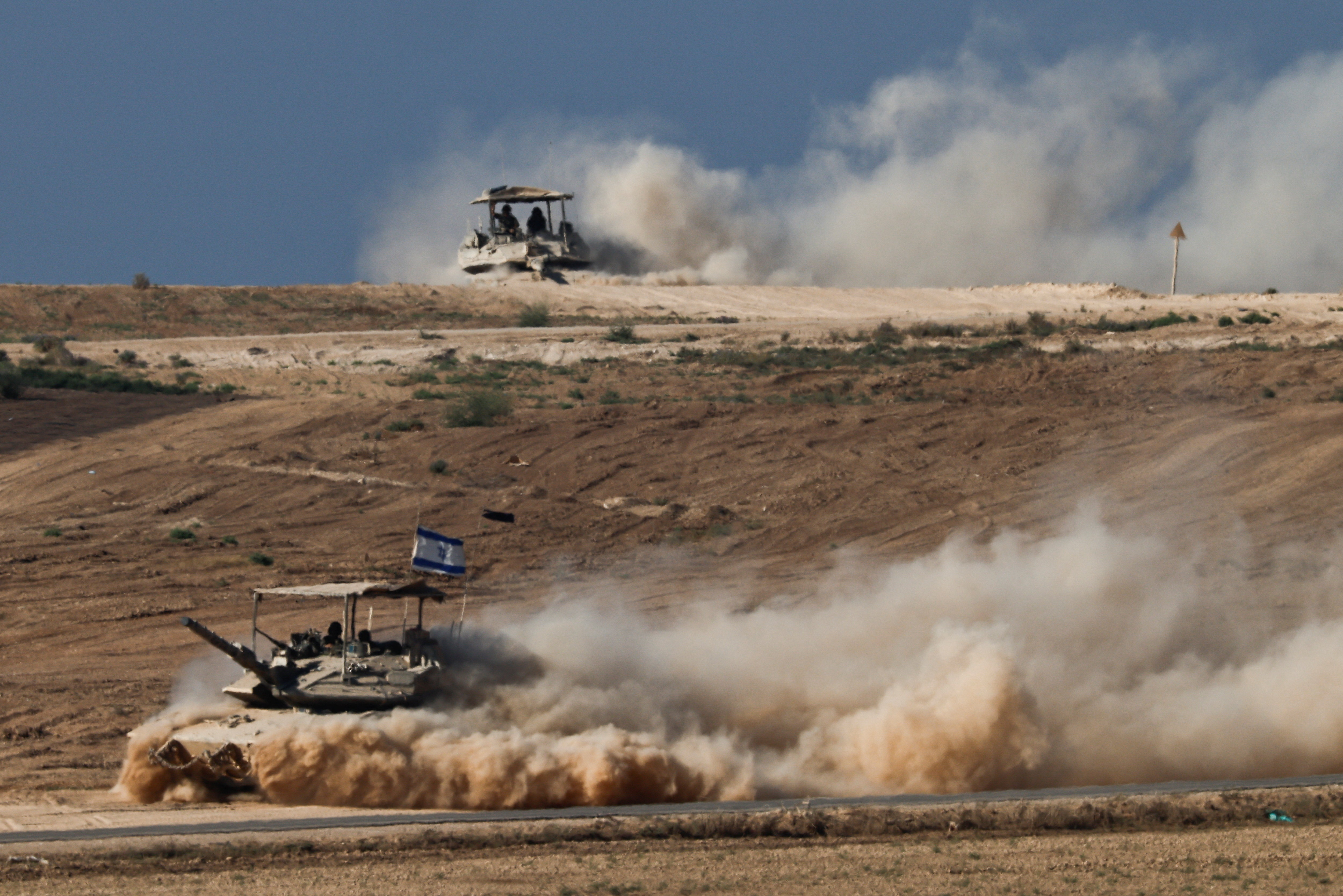 Israeli tanks manoeuvre on the Israeli side of the border with Gaza
