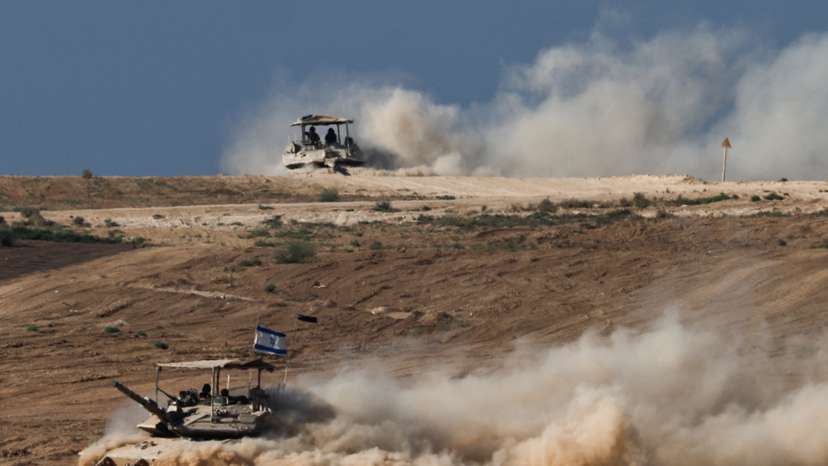 Israeli tanks manoeuvre on the Israeli side of the border with Gaza