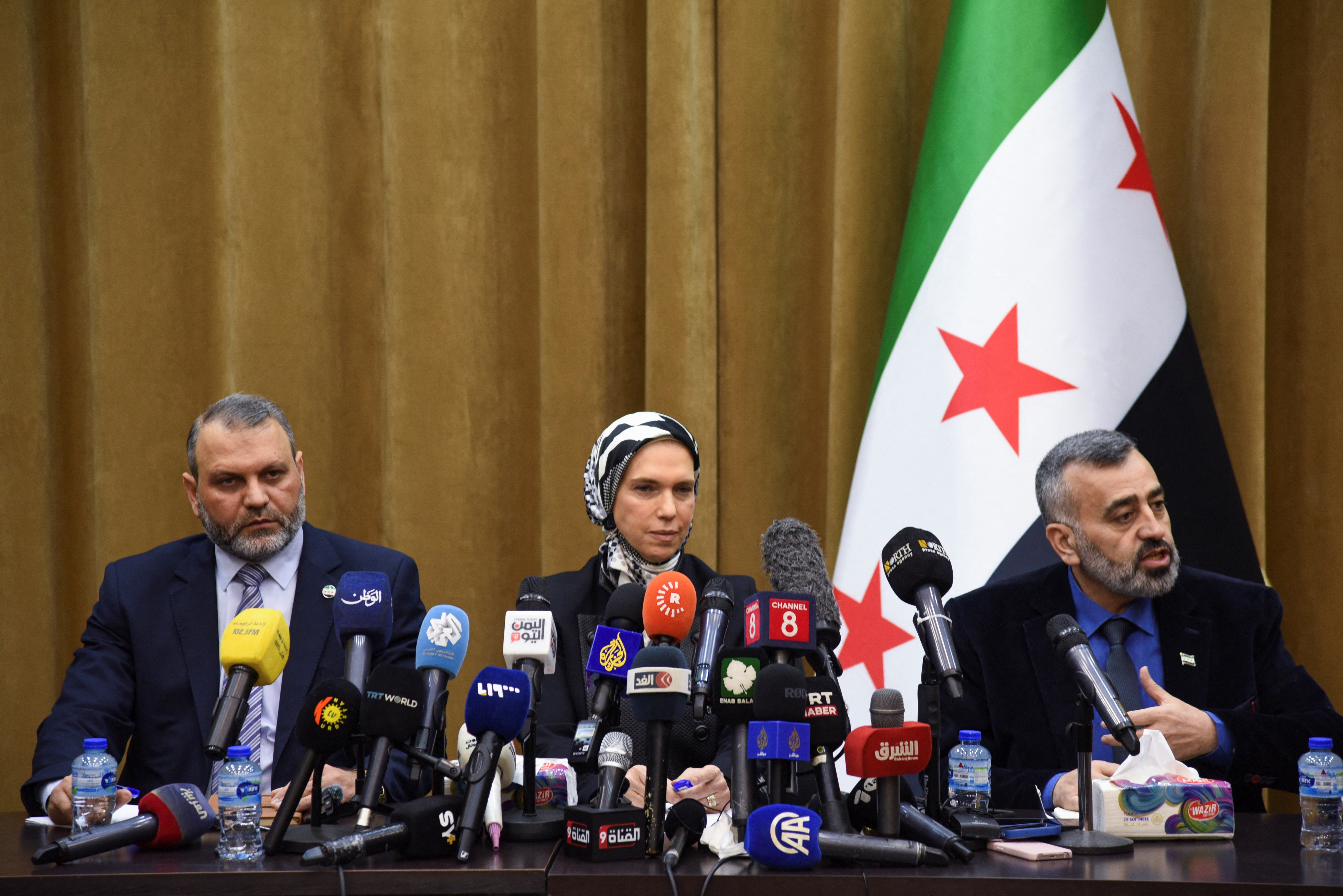 Mustafa al-Moussa, Houda Atassi, and Hassan al-Dughaim attend a press conference in Damascus