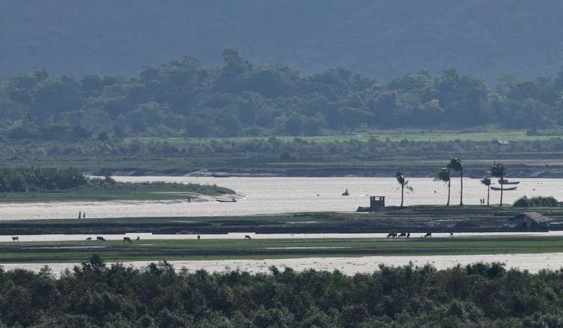 FILE PHOTO: People of Maungdaw township of Myanmar are seen from the Teknaf area of Bangladesh, at the Myanmar-Bangladesh border