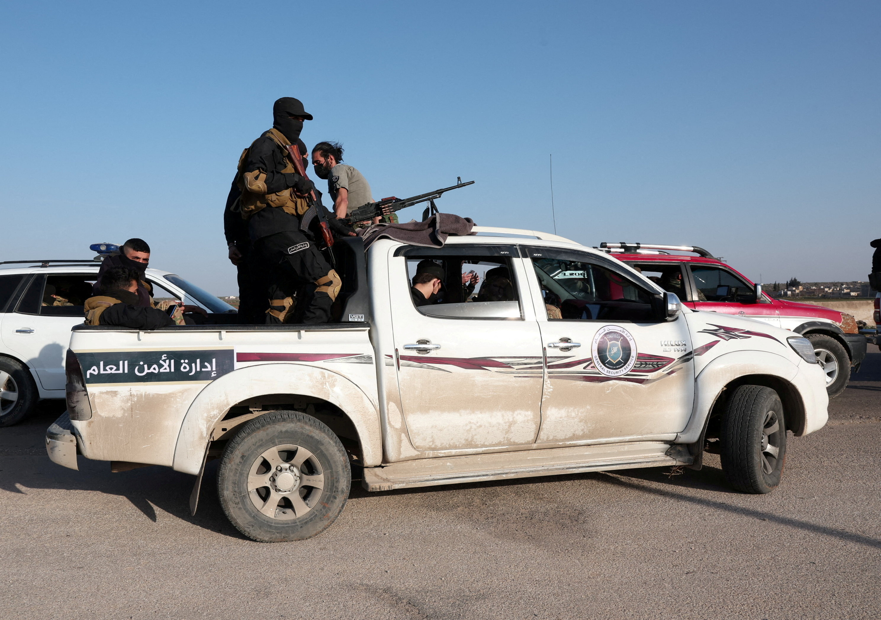 FILE PHOTO: Syrian army personnel travel in a military vehicle as they head towards Latakia to join the fight against the fighters linked to Syria's ousted leader Bashar al-Assad, in Aleppo