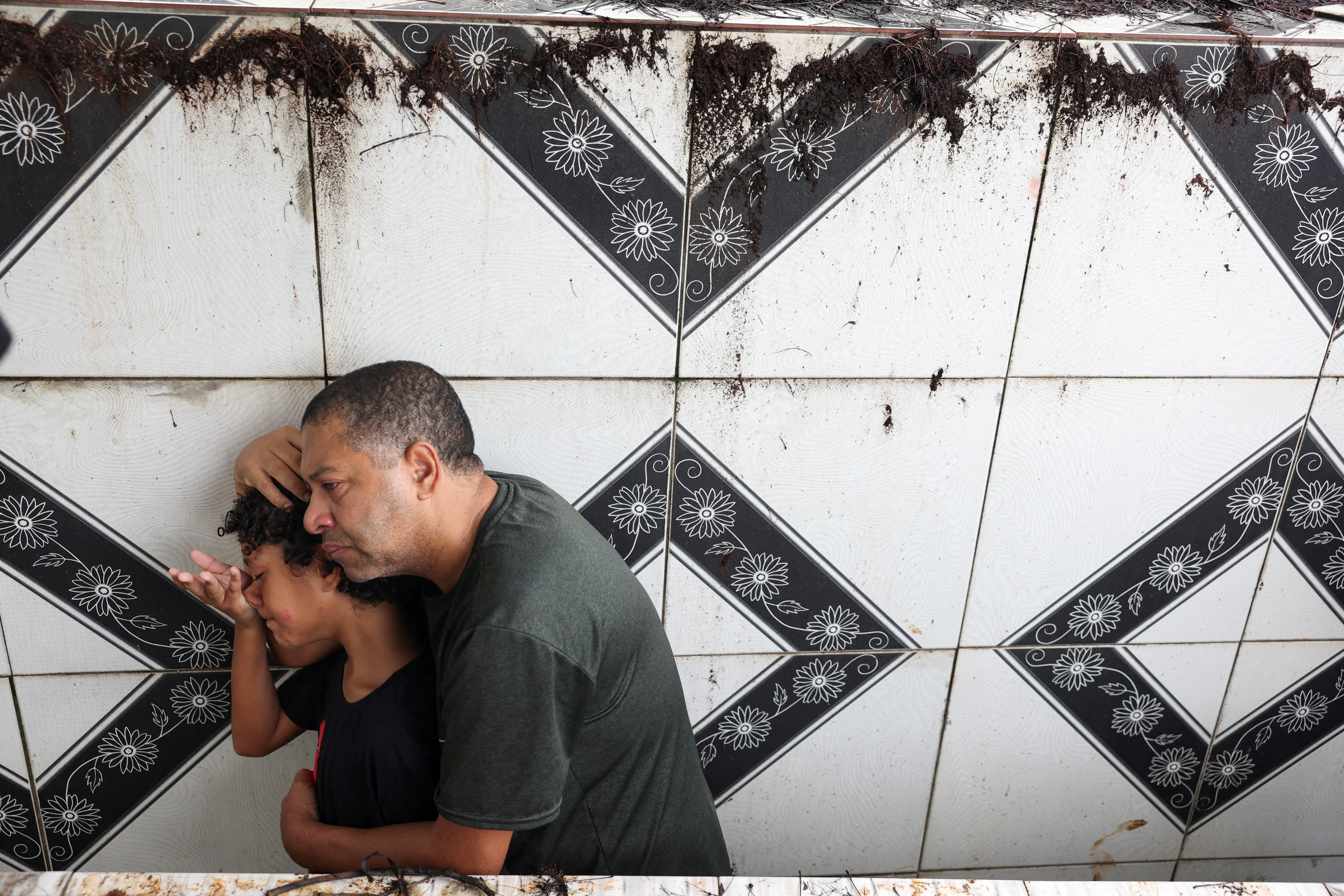 People attend the funeral of 11-year-old Bernardo Lopes Dutra, one of the victims of heavy rains in Juiz de Fora