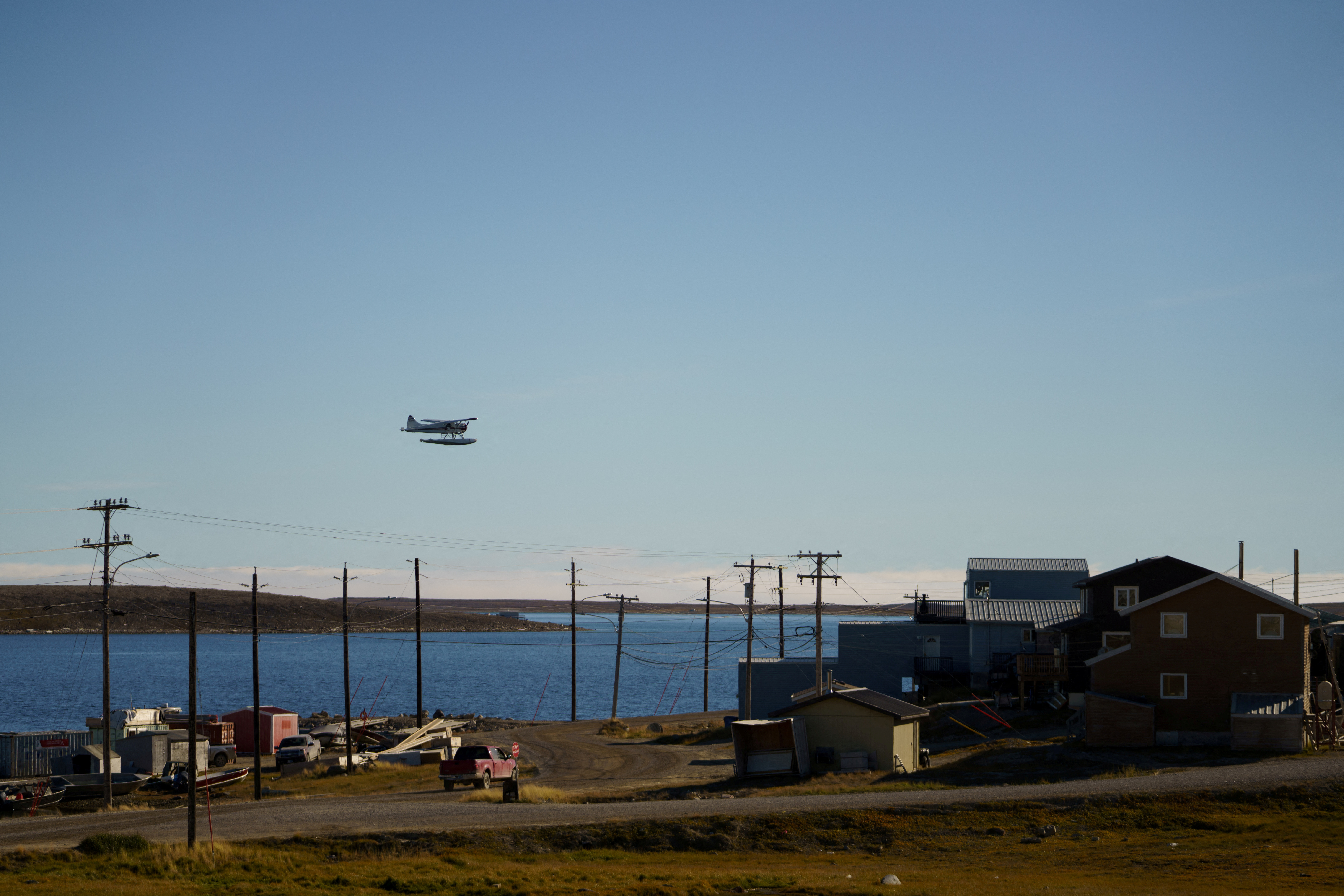 FILE PHOTO: A float plane flies past the Arctic community of Cambridge Bay