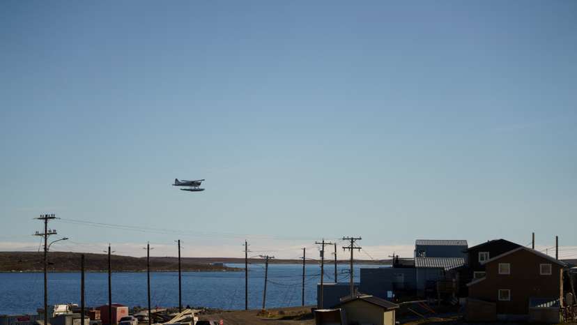 FILE PHOTO: A float plane flies past the Arctic community of Cambridge Bay