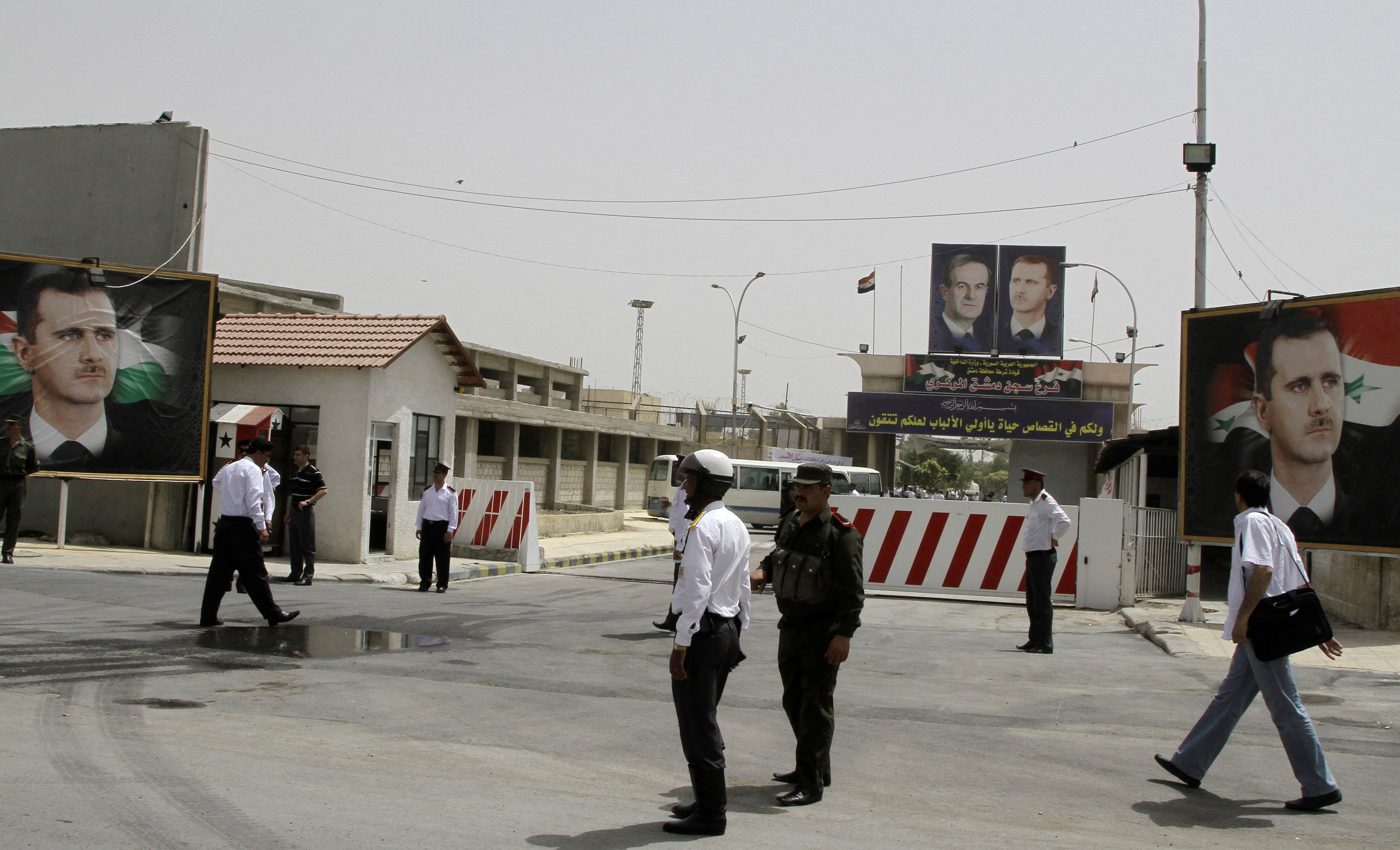 FILE PHOTO: File photo shows police standing at the gate of Damascus Central Prison in the Adra area near the Syrian capital of Damascus