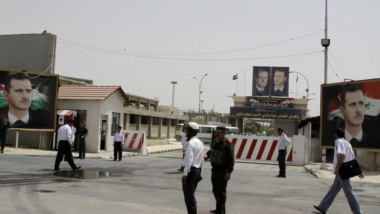 FILE PHOTO: File photo shows police standing at the gate of Damascus Central Prison in the Adra area near the Syrian capital of Damascus