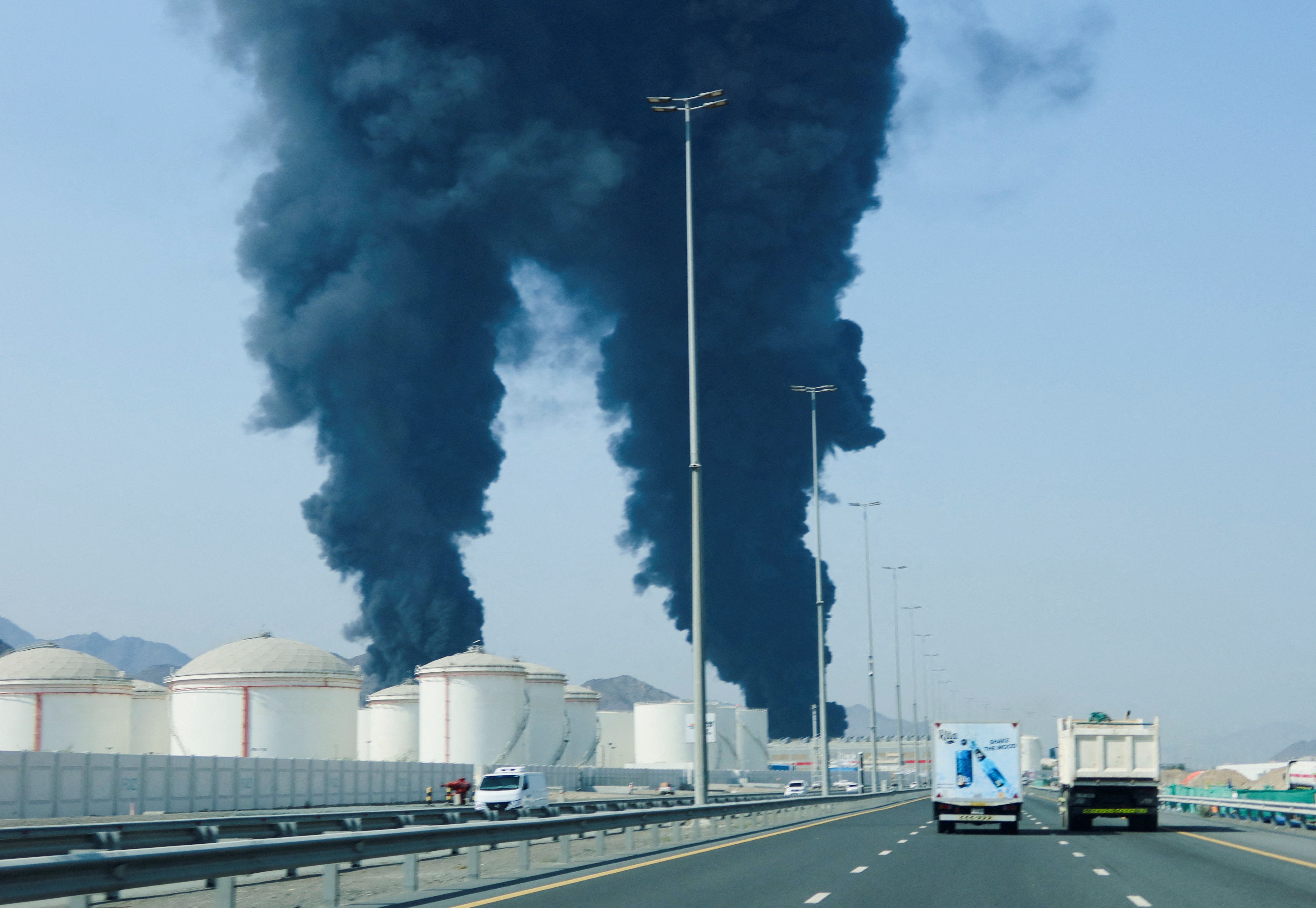 Smoke rises in the Fujairah oil industry zone, caused by debris after interception of a drone by air defenses, according to the Fujairah media office, amid the U.S.-Israel conflict with Iran, in Fujairah