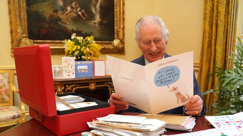 Britain's King Charles reads cards and message, in London