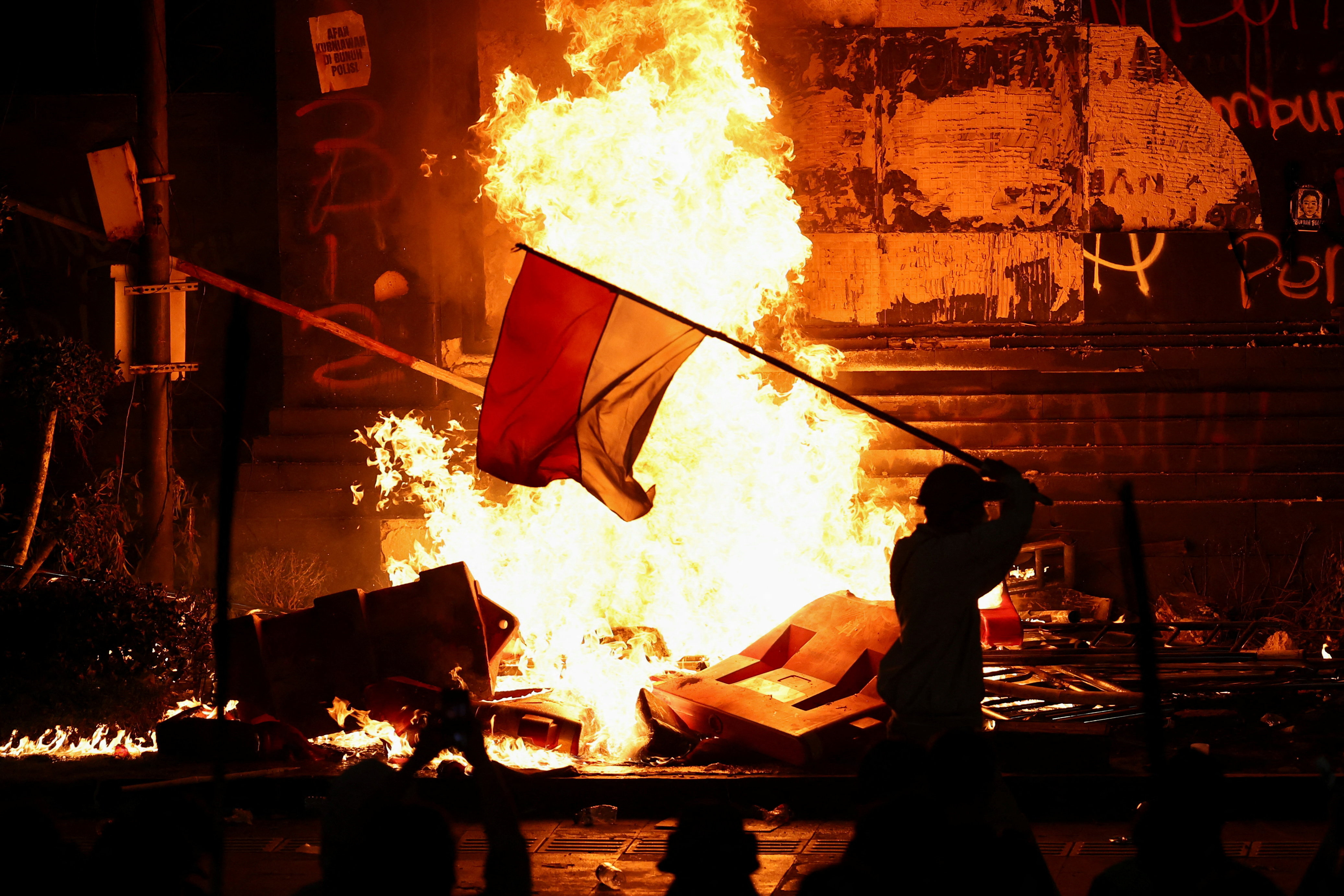 Protest outside Jakarta police headquarters, after a motorcycle taxi driver died after being struck and run over by a police tactical vehicle, in Jakarta