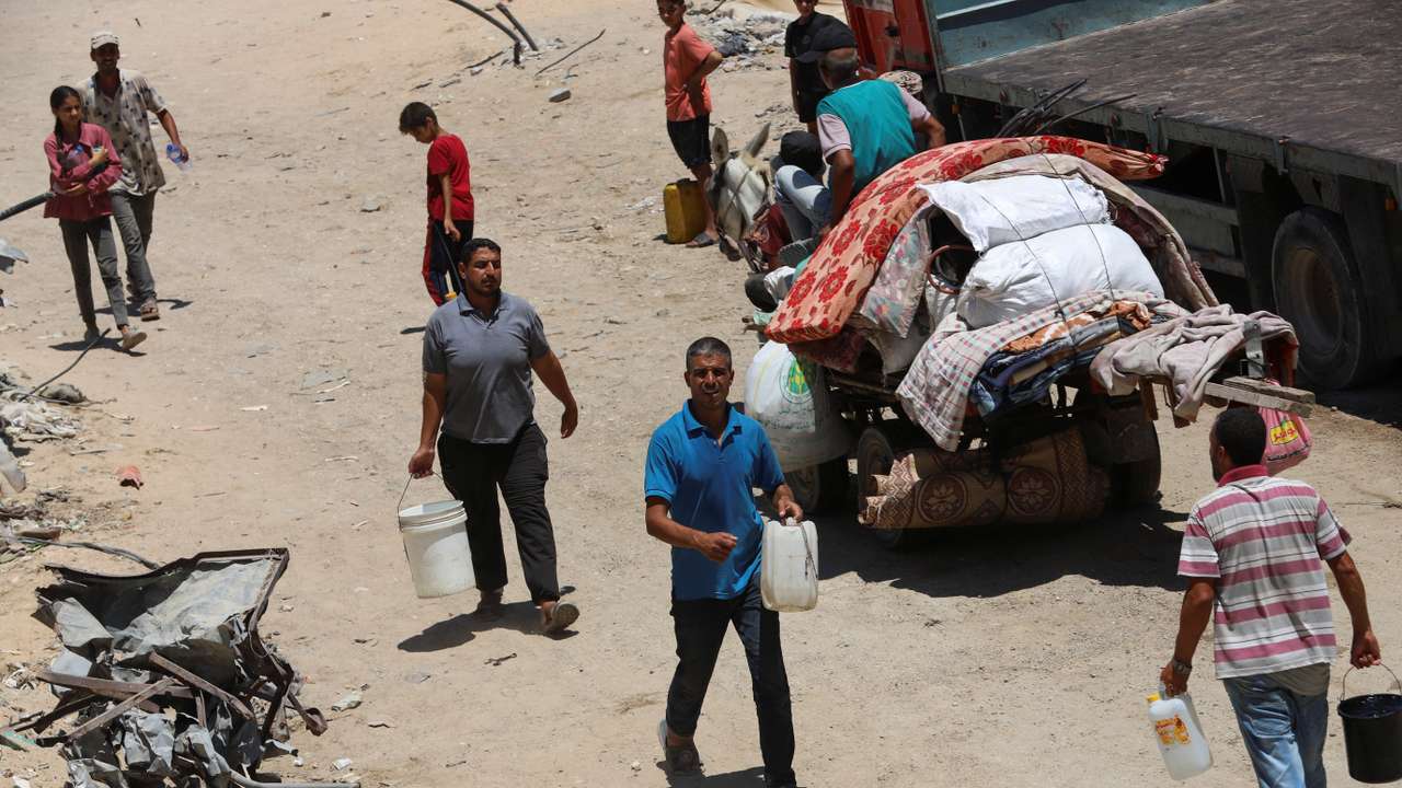 Palestinians gather to collect water amid shortages in Khan Younis in the southern Gaza Strip