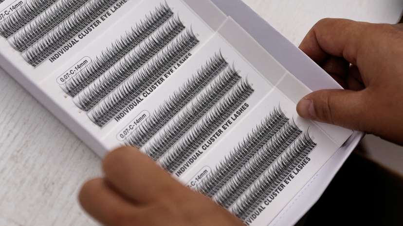 Worker works on a production line manufacturing false eyelashes at a workshop of Monsheery, in Pingdu